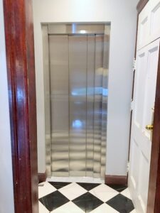 Residential Elevator with reflective metal sliding doors