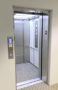 A shiny metallic elevator for commercial use